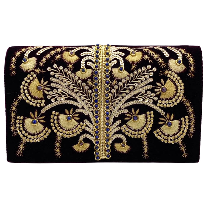 A purple velvet clutch with gold beadwork and embroidery, featuring a removable gold-toned chain shoulder strap.