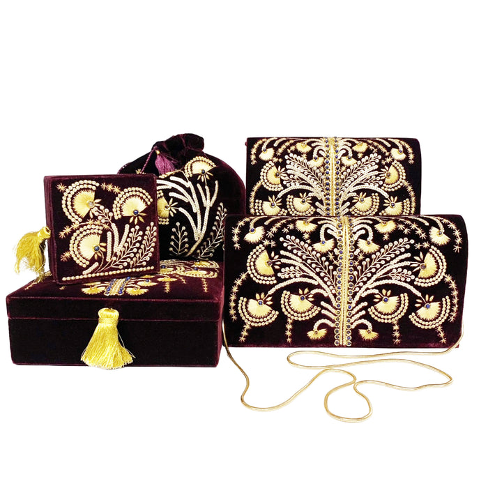 Collection of purple velvet boxes and bags with gold embroidery.