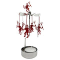 Decorative candle holder with red figurines on a white background