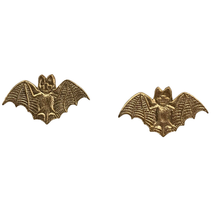 A pair of hand-hammered brass earrings in the shape of bats in flight, with sterling silver posts.