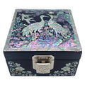 A Korean handcrafted jewelry box with a mother of pearl design featuring two cranes on the lid.