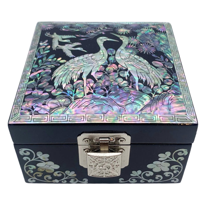 A Korean handcrafted jewelry box with a mother of pearl design featuring two cranes on the lid.