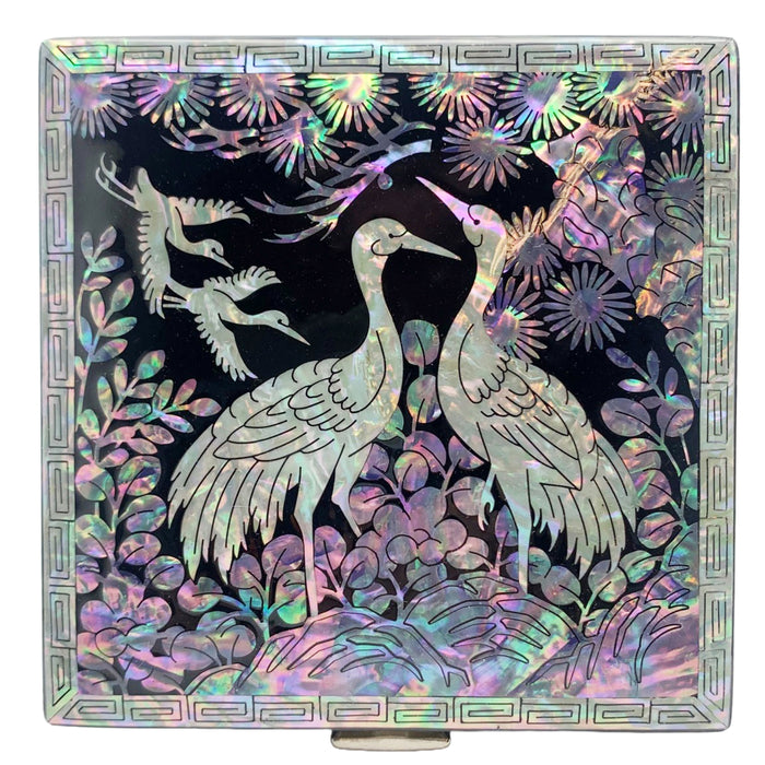A Korean handcrafted jewelry box with a mother of pearl design featuring two cranes on the lid.