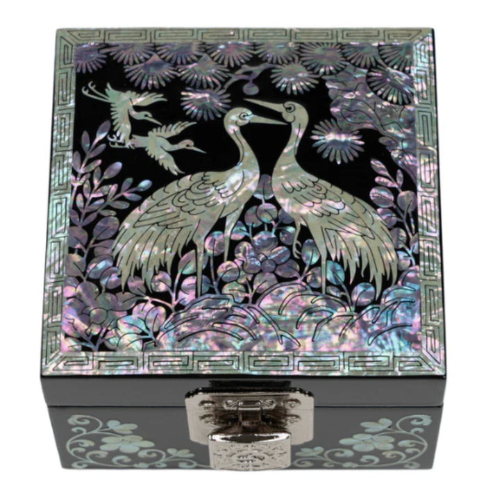 A Korean handcrafted jewelry box with a mother of pearl design featuring two cranes on the lid.