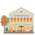 A handcrafted wooden model of the historic East India Marine Hall, decorated with autumn-themed elements such as pumpkins and fall foliage.