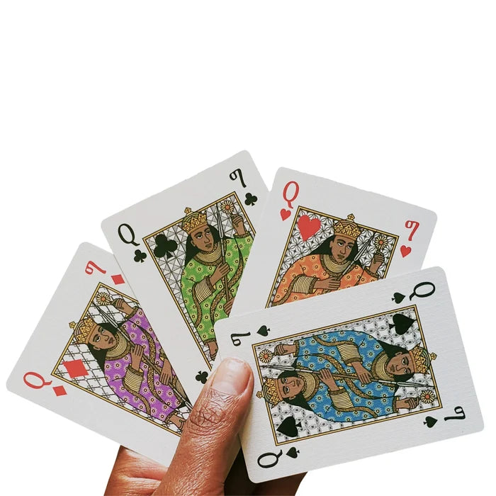 A hand holding four playing cards.