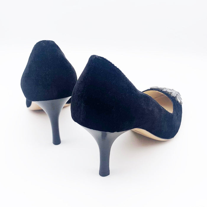 A pair of black velvet high-heeled shoes with dark grey rhinestone embellishments on the front, designed by Emma Hope.