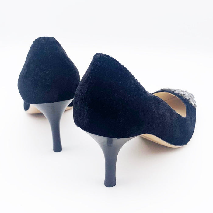 A pair of black velvet high-heeled shoes with dark grey rhinestone embellishments on the front, designed by Emma Hope.