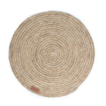 Round handwoven, natural fibre placemat made by Colombian artisans in beige tones.